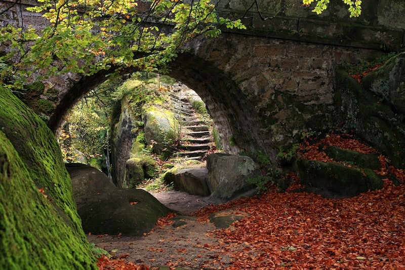 stone arch on pathway in fall