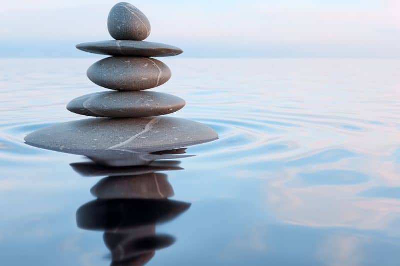 stones stacked in water Balanced stones reflected in still water — a calming, grounding image